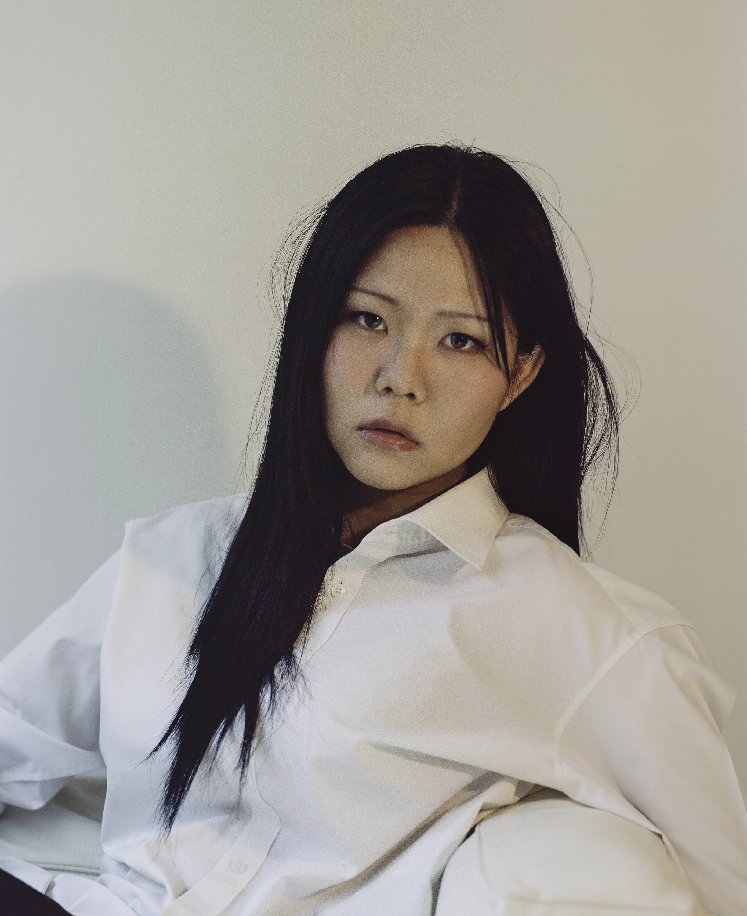 Portrait — M. after school, leaning against a wall